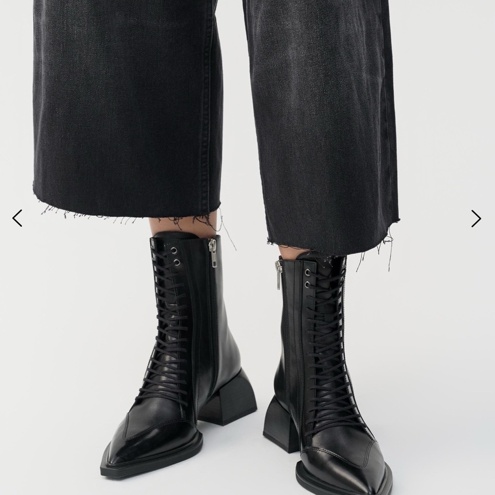 Black ankle-high leather boots with pointed toe and lace-up design